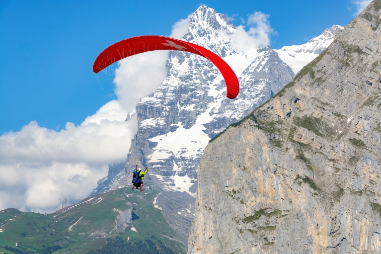 A paraglider flies in front of the Eiger mountain in the Jungfrau region. 