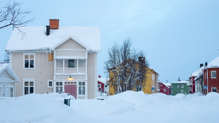 A residential neighbourhood of Kiruna, covered in snow, during dawn