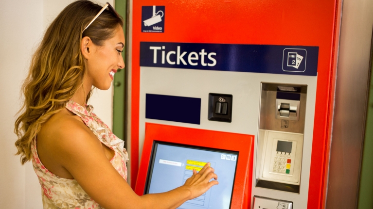 Woman at ticket machine