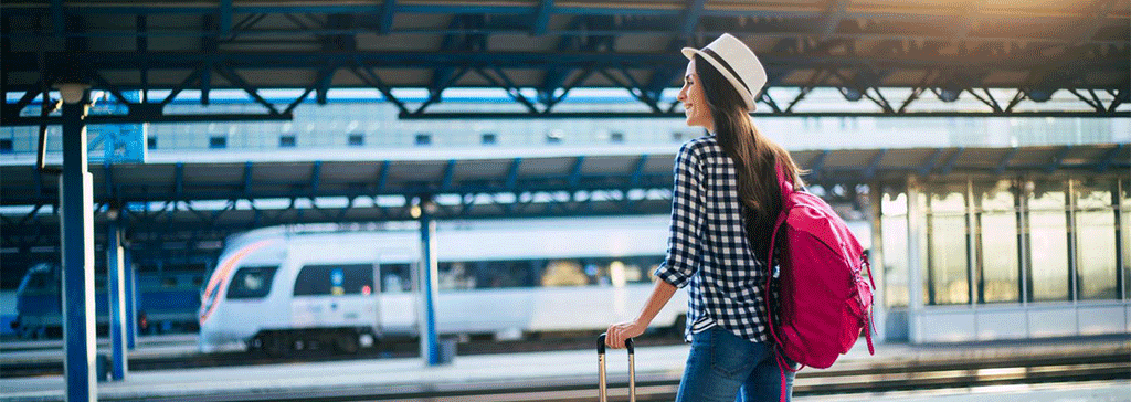 header-woman-station-platform-suitcase-holiday