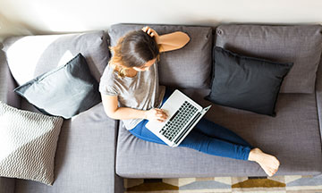 coping-with-quarantine-girl-on-couch-with-laptop