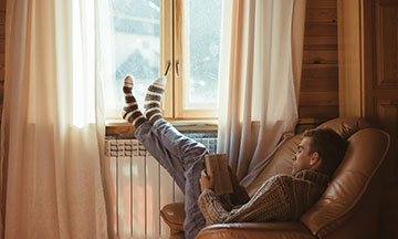 man-reading-book-in-chair