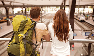 couple-looking-at-trains-on-train-station