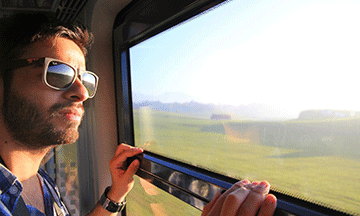 guy-looking-out-of-train-window-spain