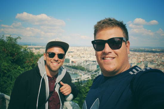 interrail_customer_testimonials_-_two_young_men_taking_a_selfie_with_a_cityview_in_the_background