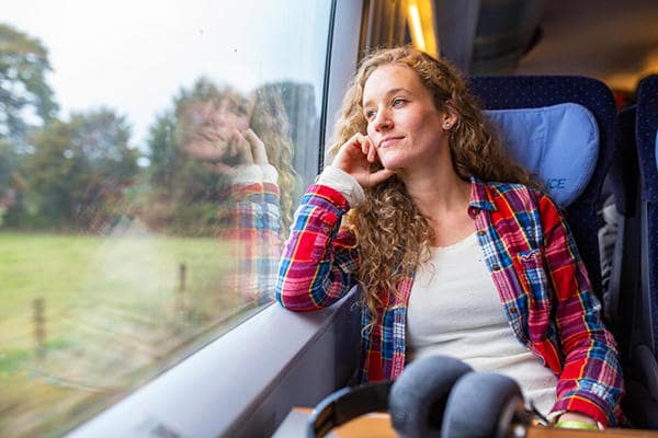 young_woman_looking_out_of_a_train_window