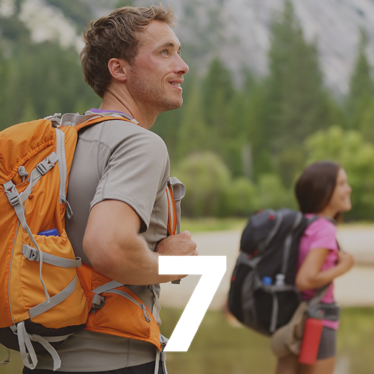 A man with a backpack in a mountainous setting. Super-imposed is the number 7