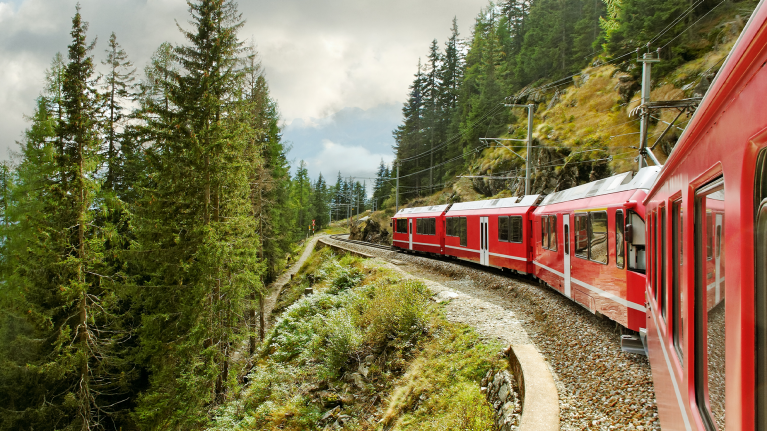 red-train-in-green-landscape