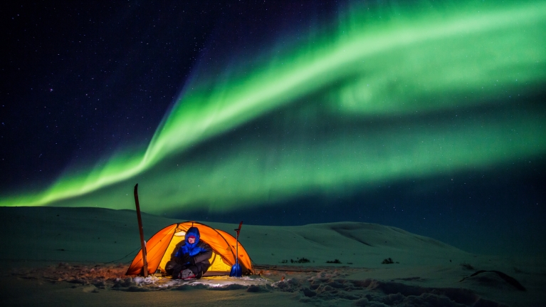 norway-northern-lights-person-camping