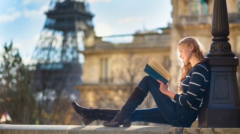 Woman reading a book in Paris