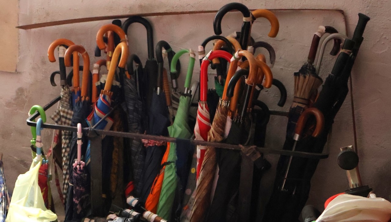 Colourful umbrellas leaning against a wall